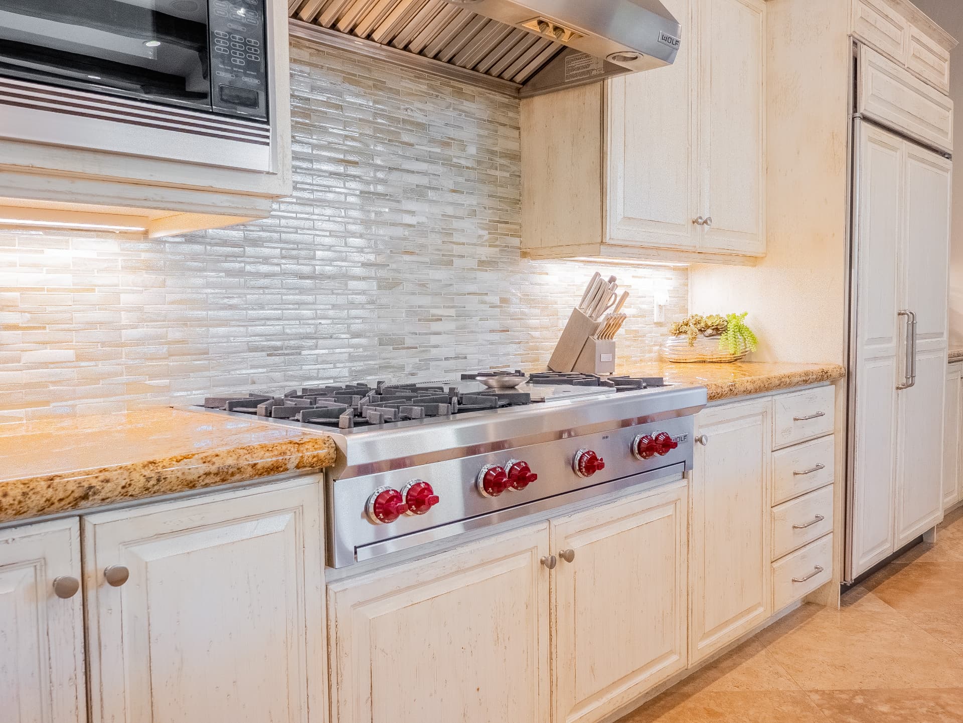Detail of the Wolf gas range and glass mosaic backsplash