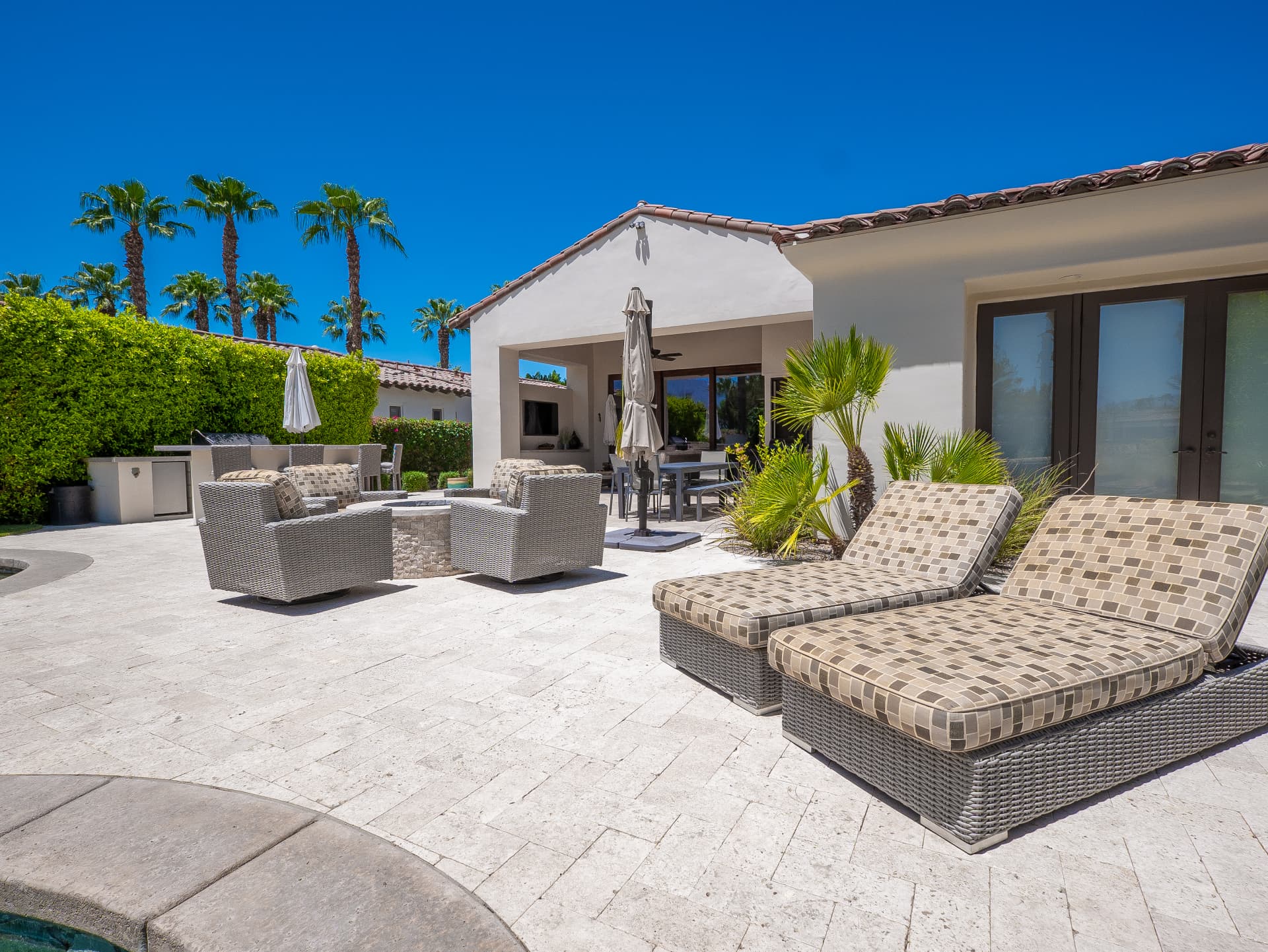 Pool terrace with fire pit lounge, dining and covered patio
