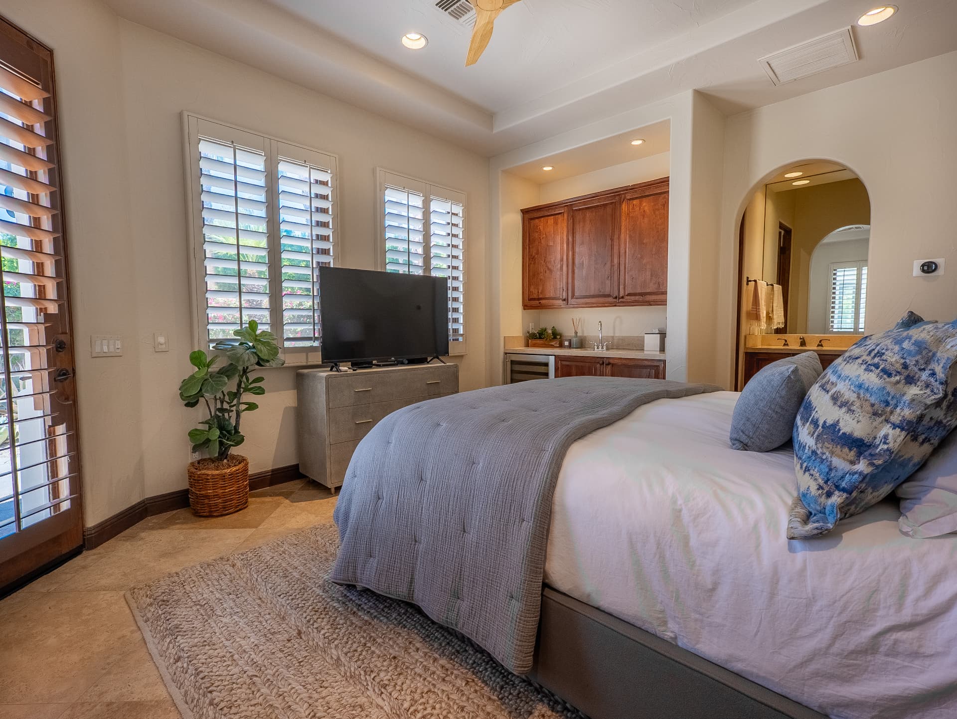 Guest suite with king bed, plantation shutters and private wet bar