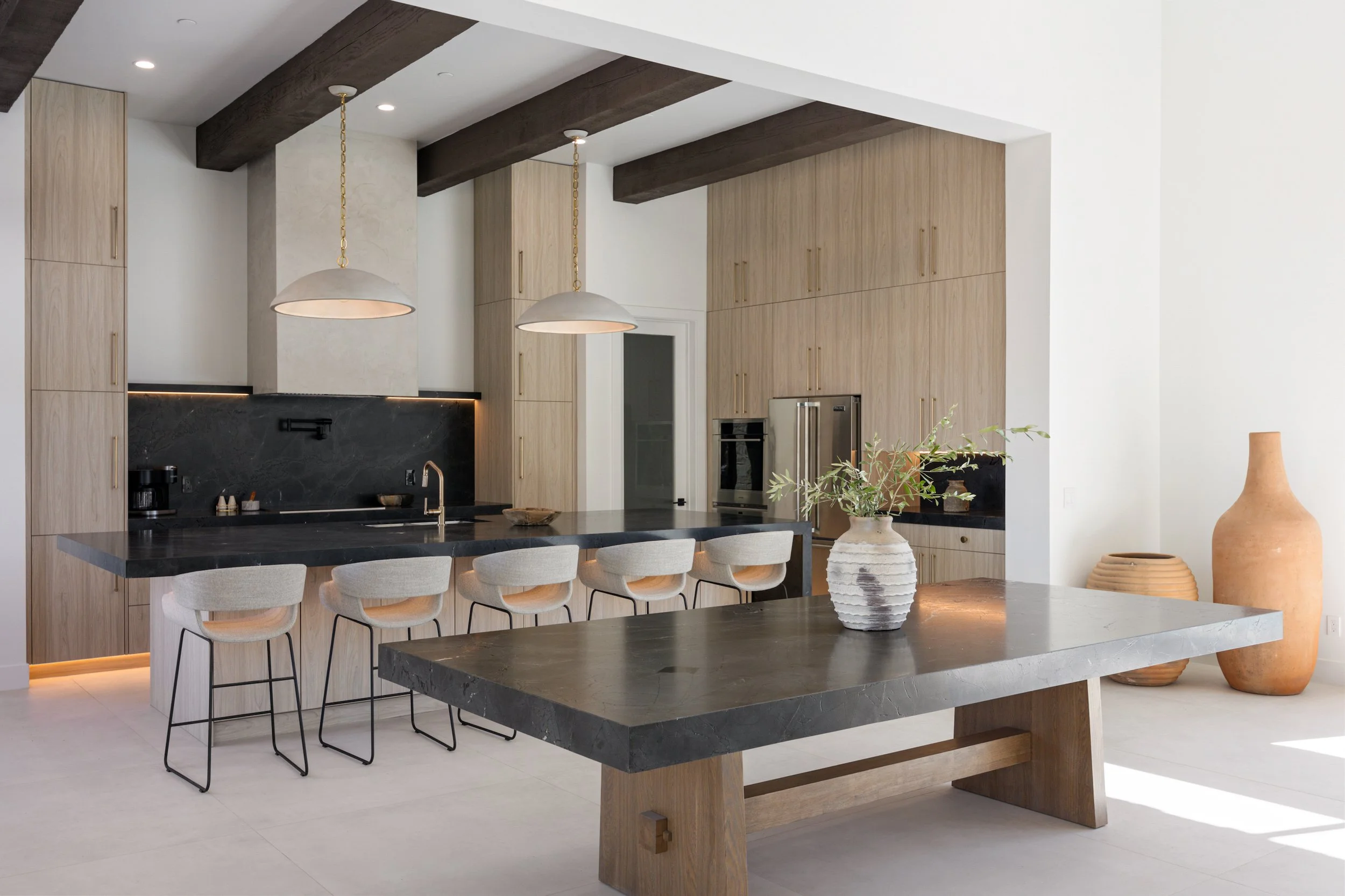 Chef's kitchen with marble counters and barstool seating