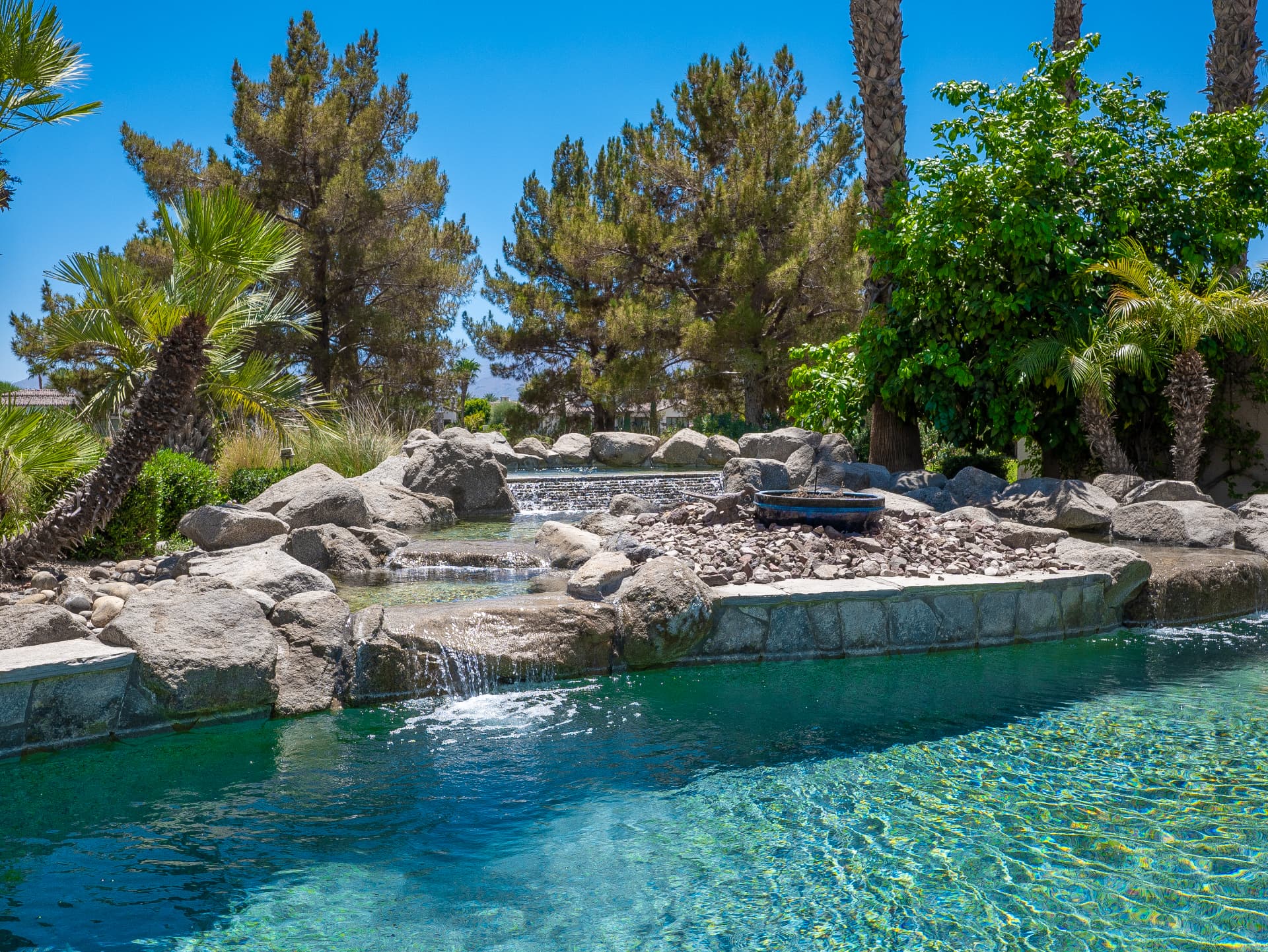 Cascading waterfalls and boulder spa spilling into the pool