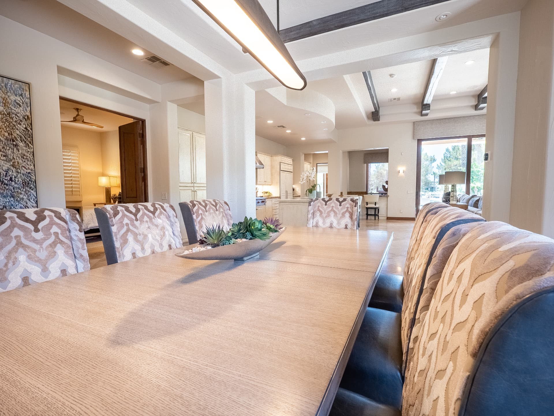 View along the dining table toward the kitchen and great room