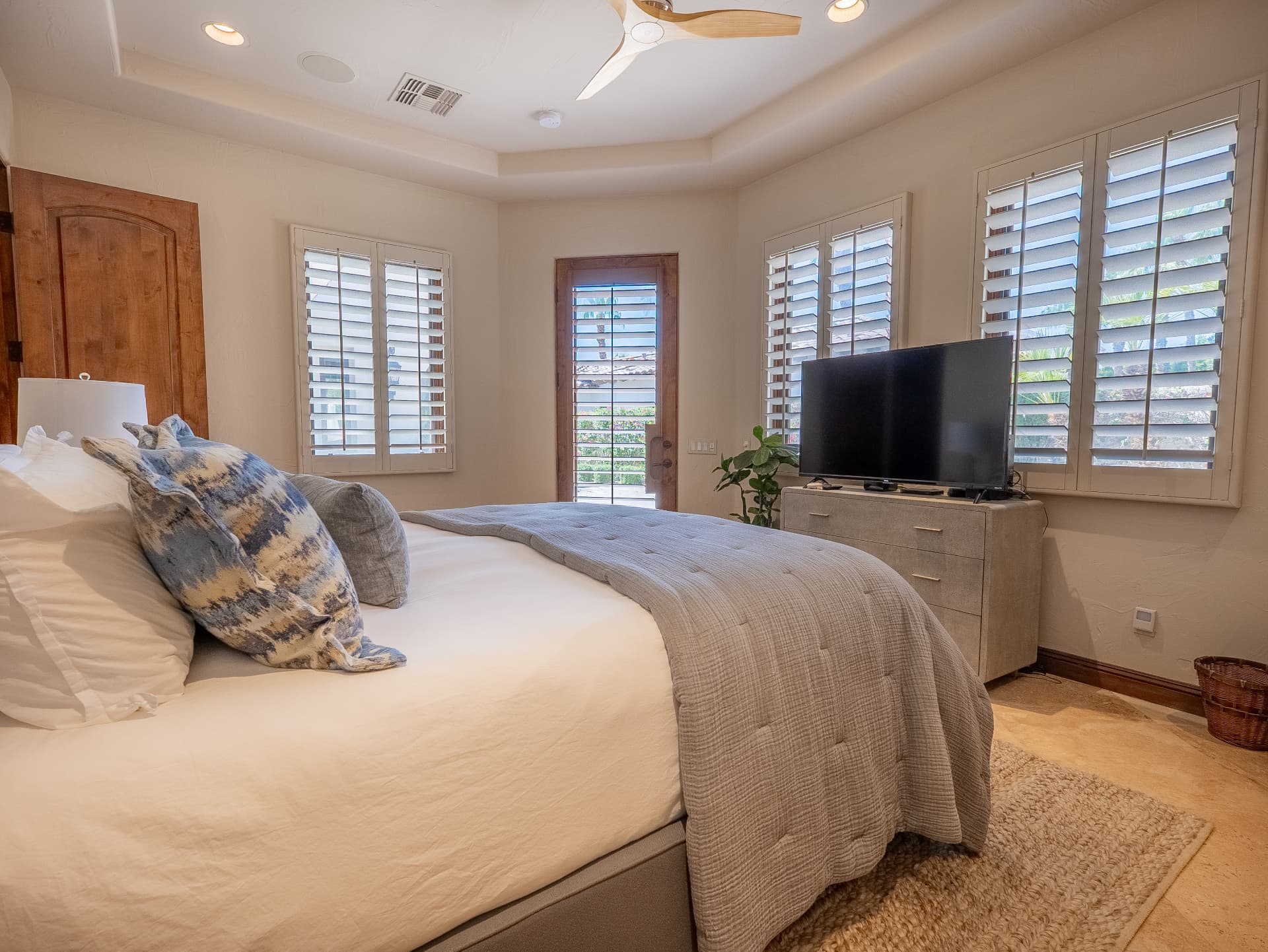 Corner bedroom filled with natural light and garden views