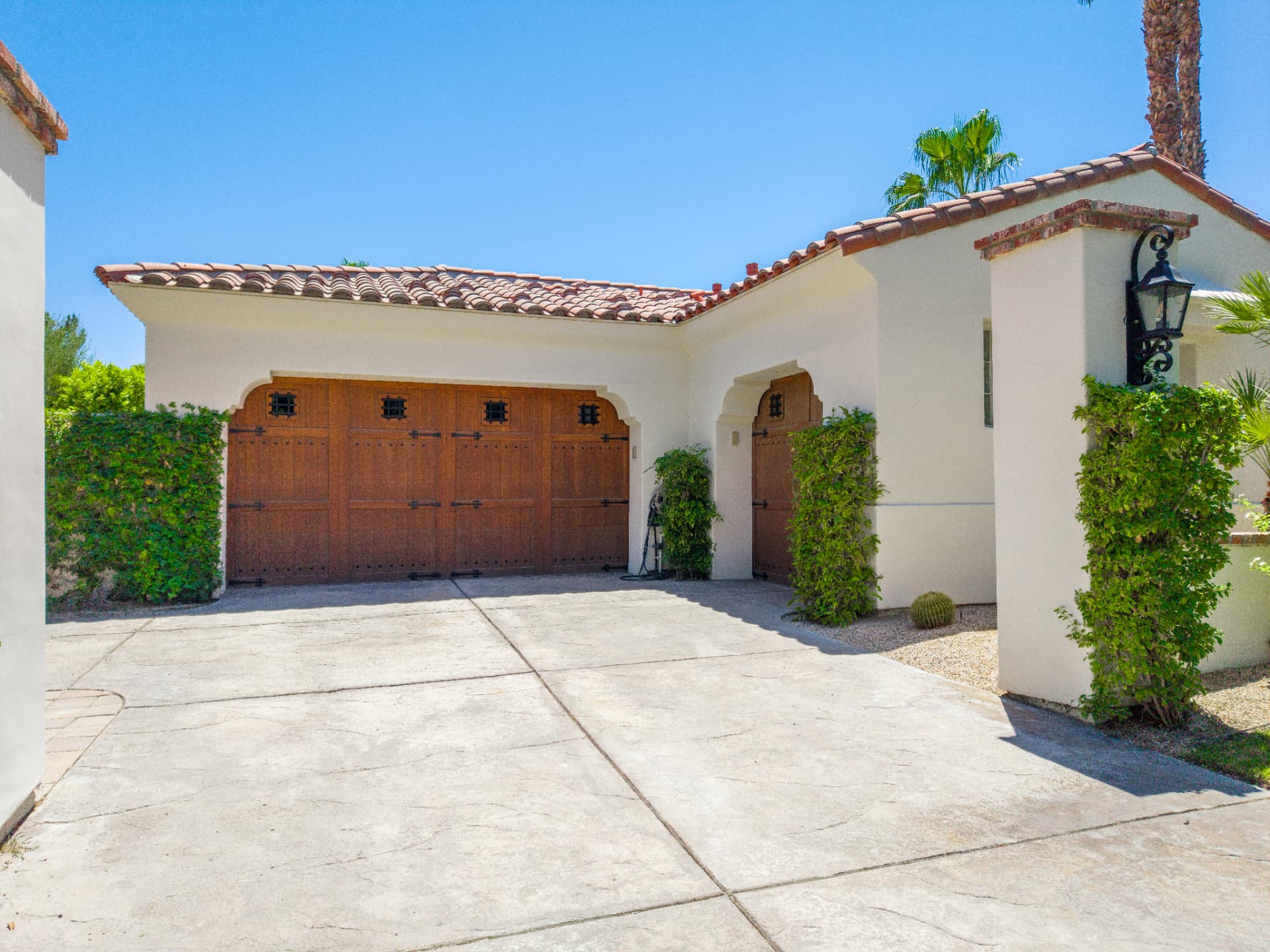 Courtyard entry and garage with wrought iron lantern