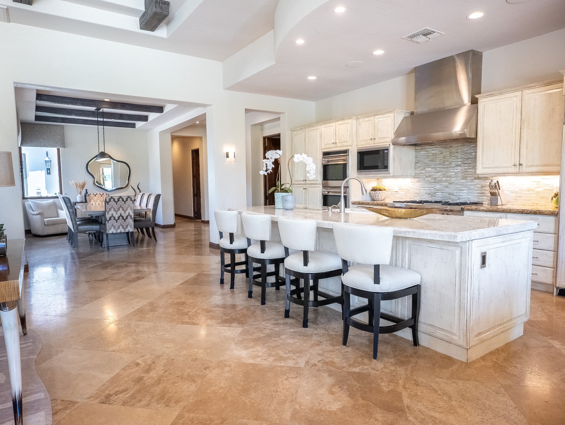 Kitchen bar seating with the formal dining room beyond
