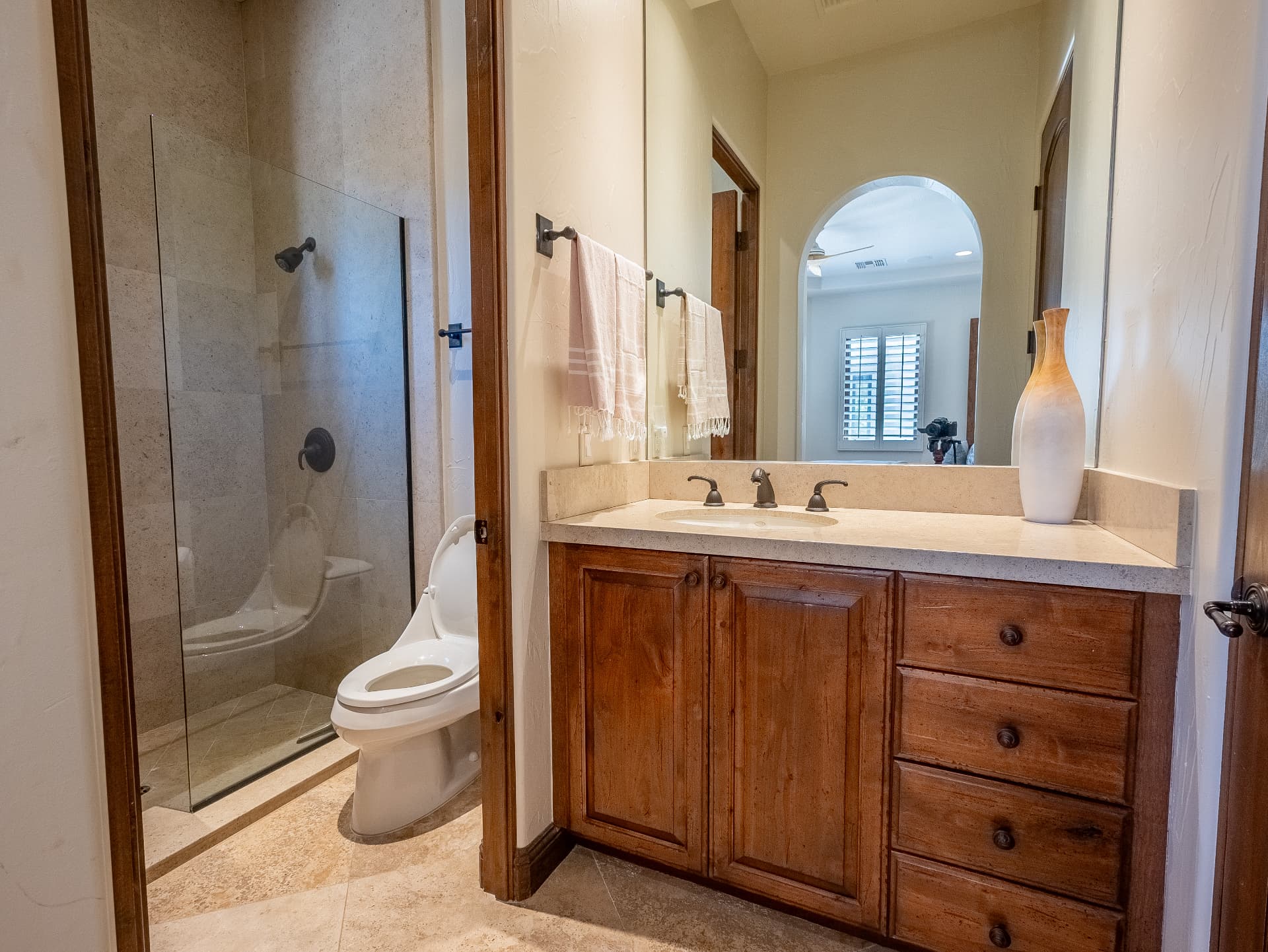 Ensuite bath with walk-in stone shower and stone vanity