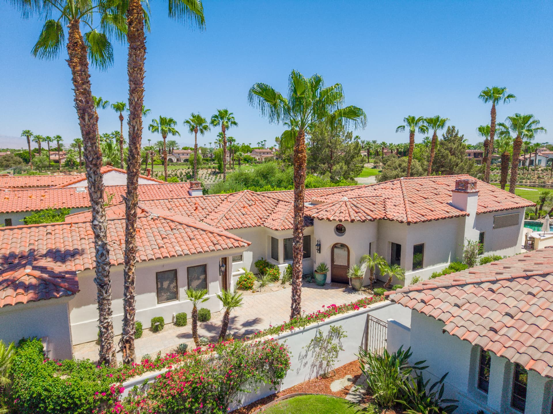 Aerial of the entry courtyard with golf course backdrop