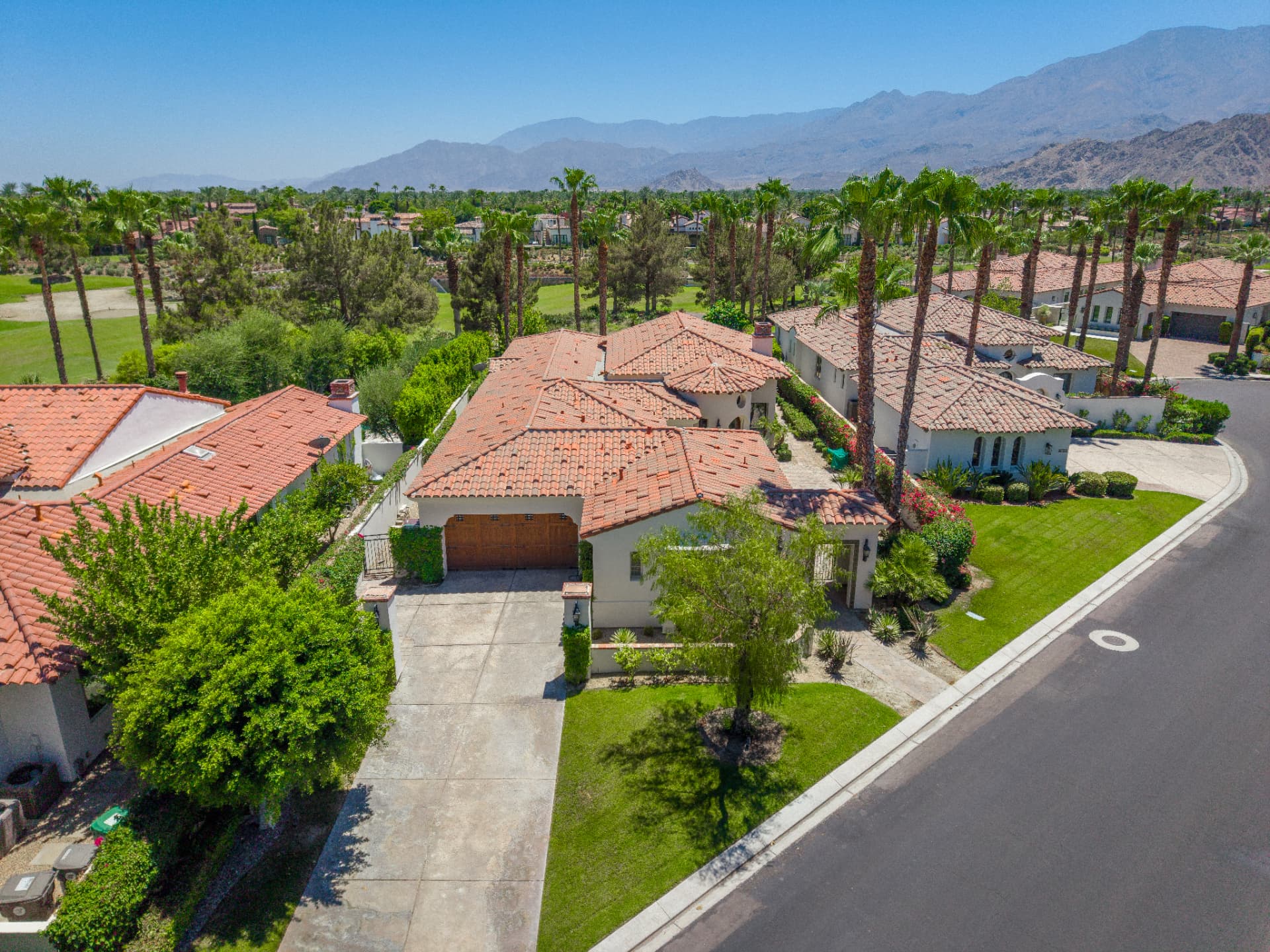 Elevated view of the home with mountain range beyond