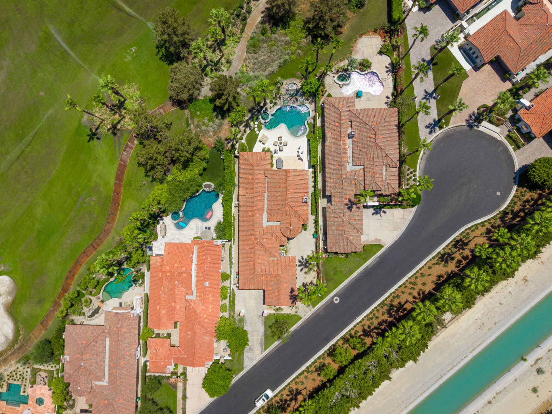 Overhead view of the property, pool and adjacent fairway