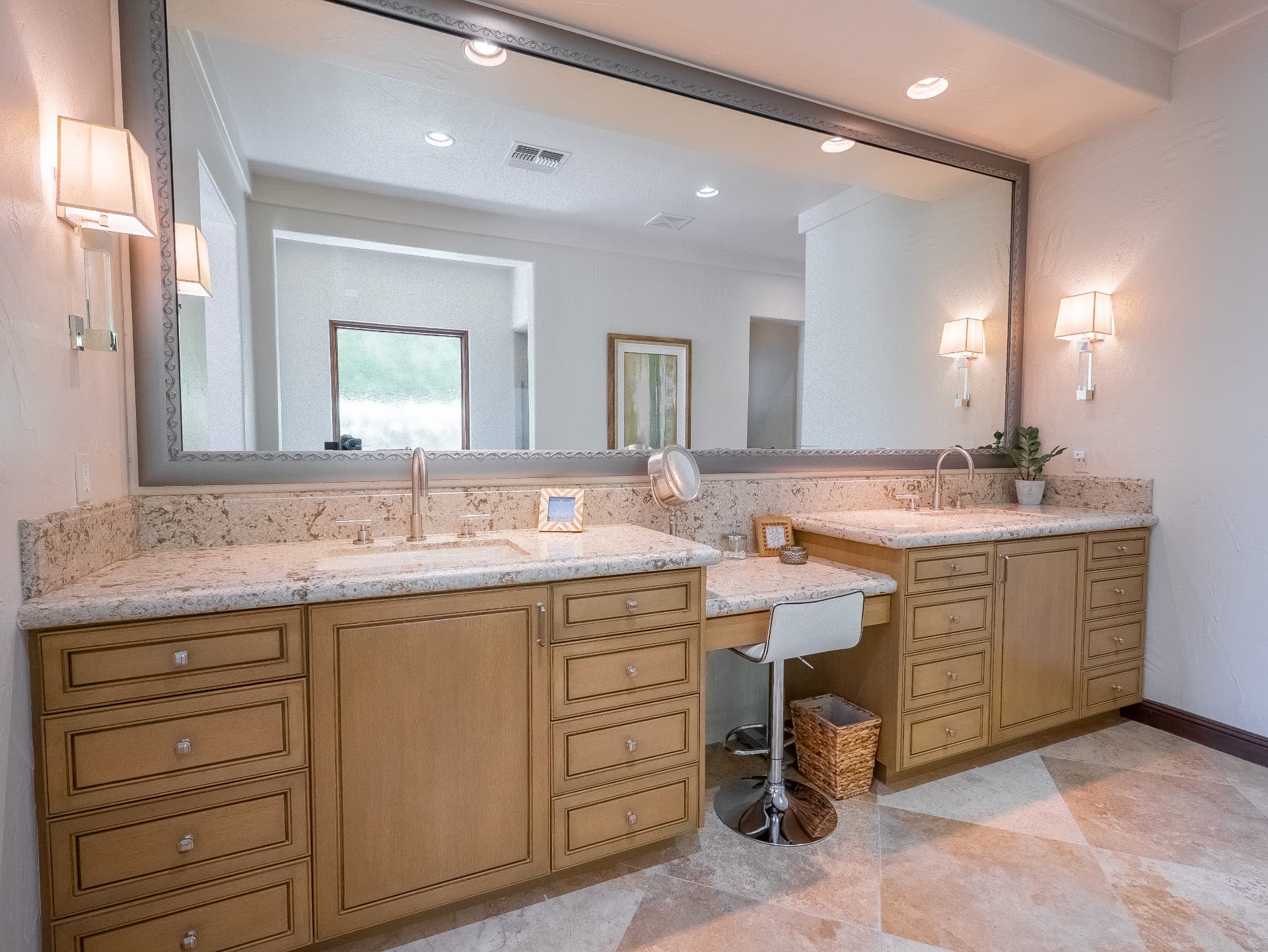 Primary bath with dual vanities, vanity seating and large mirror