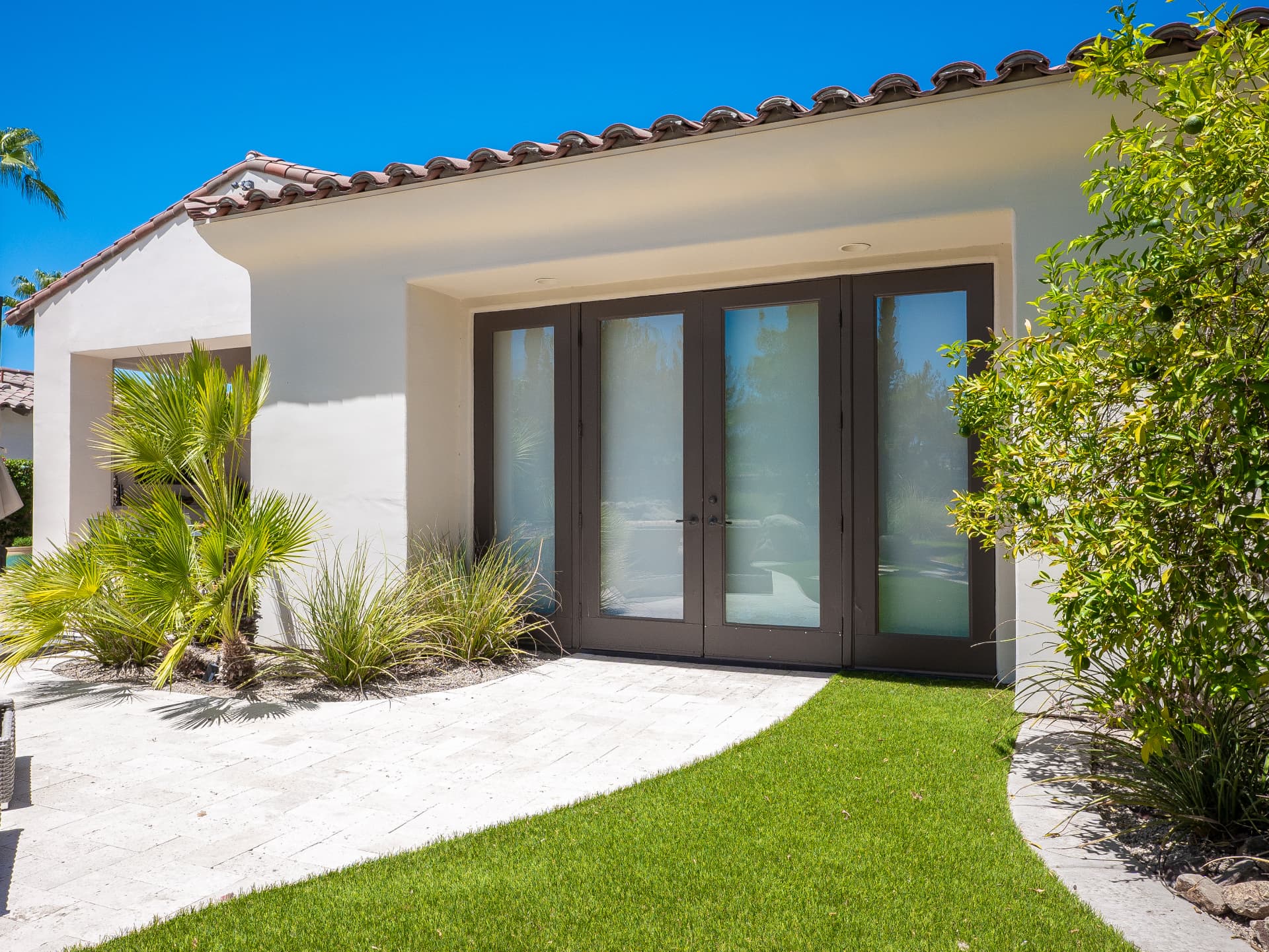 Casita French doors opening to the lawn and pool terrace