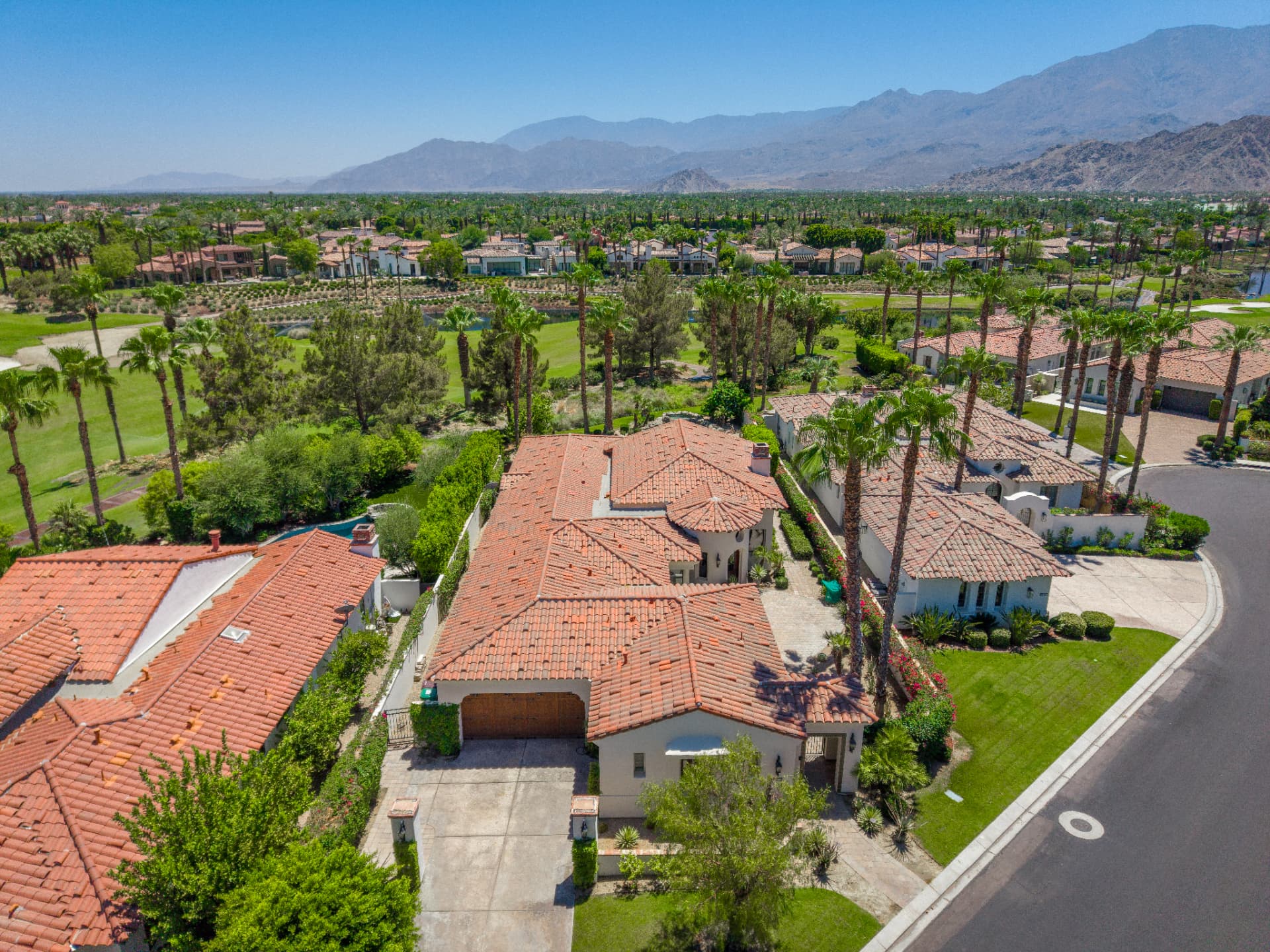 Wide aerial of the golf course lakes and desert valley