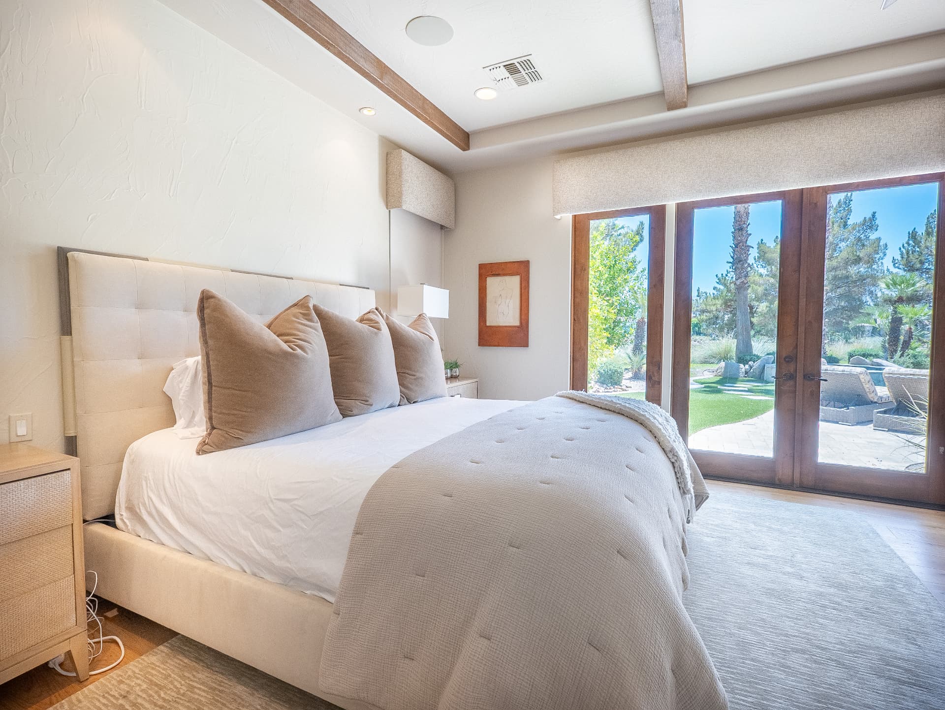 Bedroom with king bed and French doors opening to the pool terrace