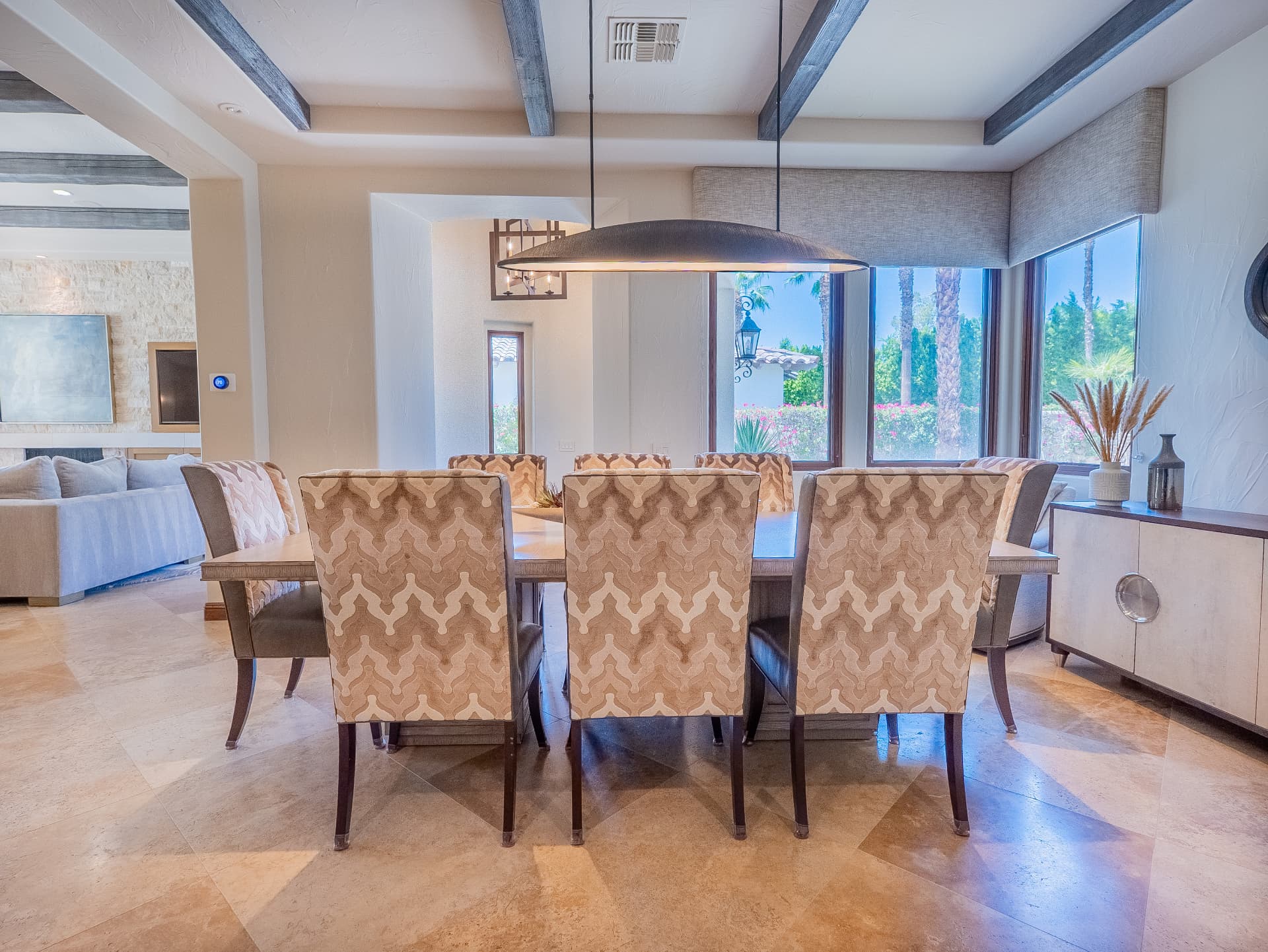 Dining table for eight open to the great room with fairway views