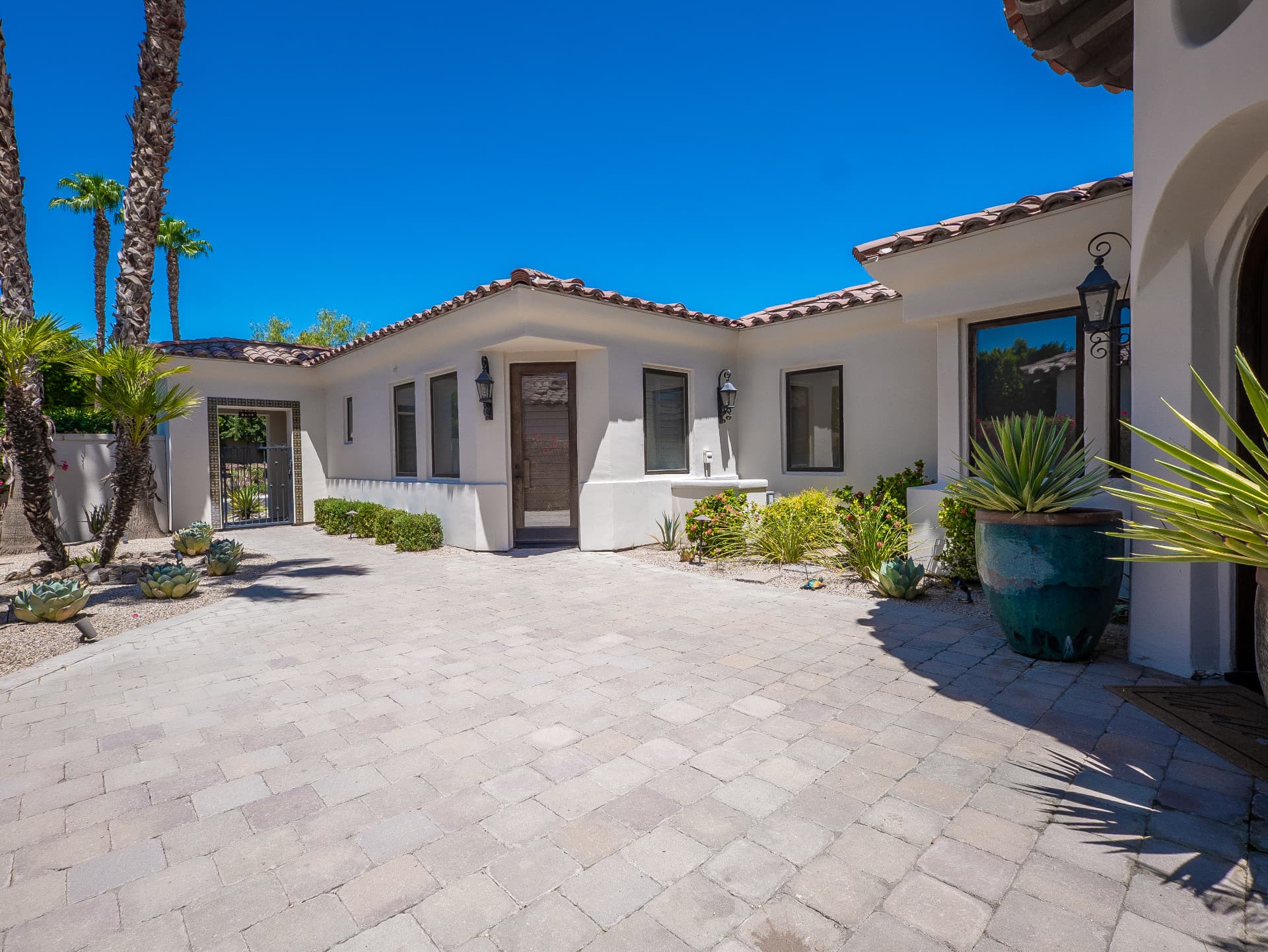 Front courtyard with paver drive, succulents and casita entry