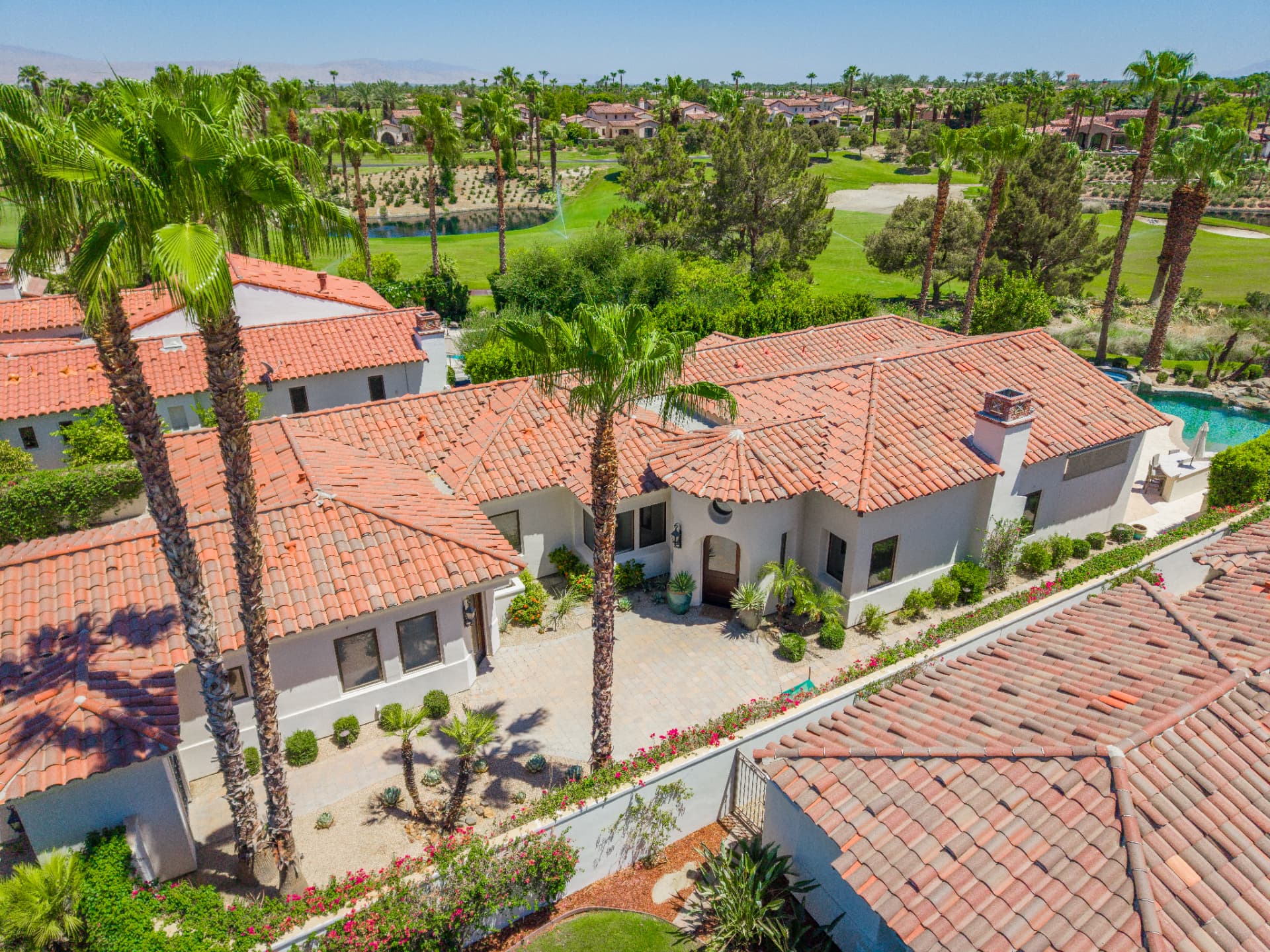 Aerial view of the residence with fairways and lakes beyond