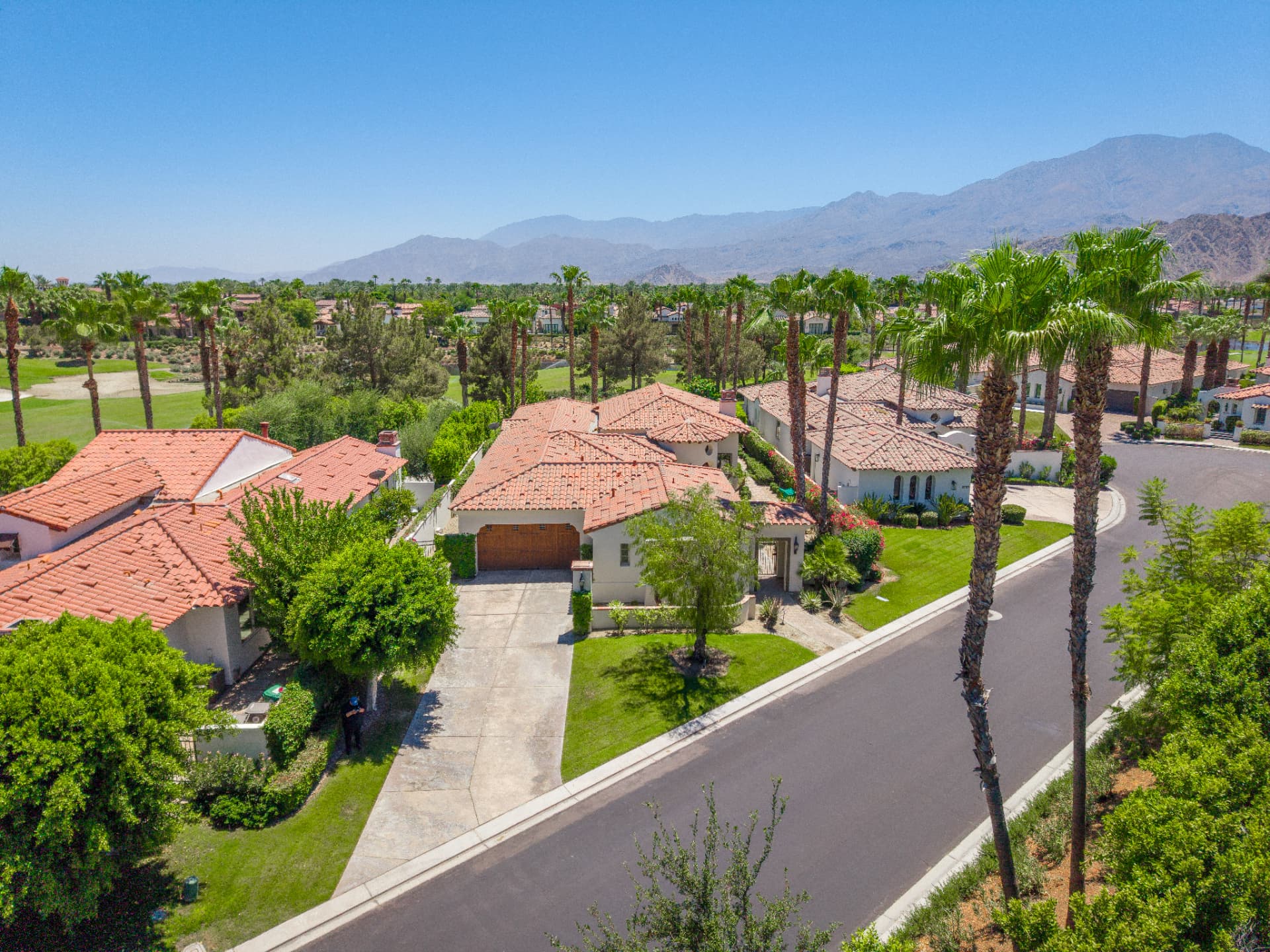Aerial view of the residence, fairways and surrounding mountains
