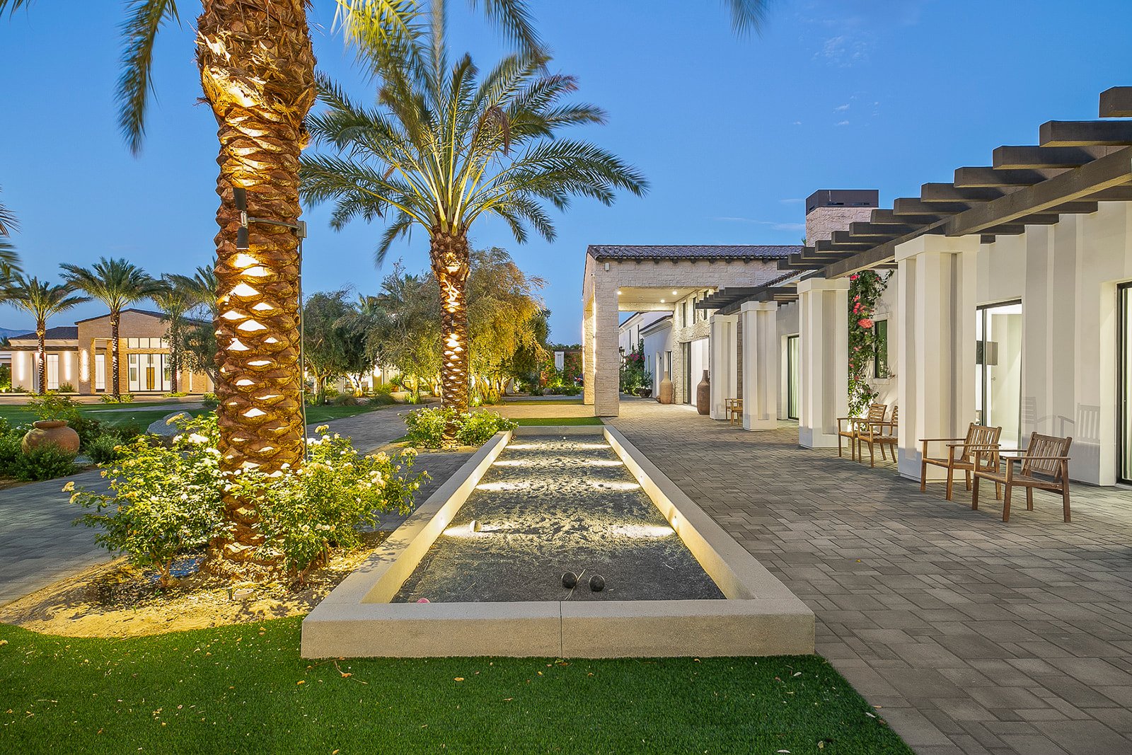 Bocce court and courtyard illuminated at twilight