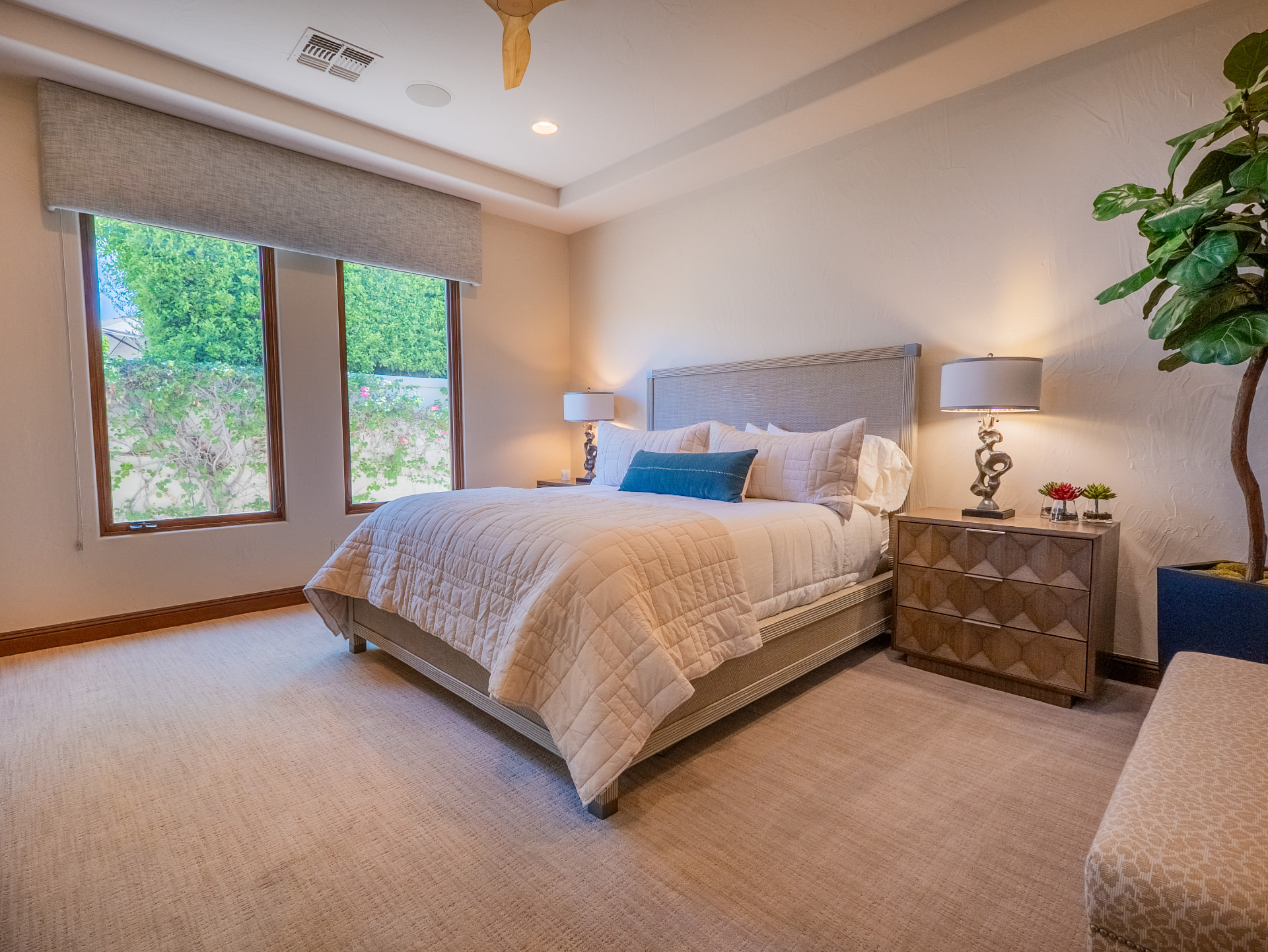 Light-filled guest bedroom with king bed and garden views
