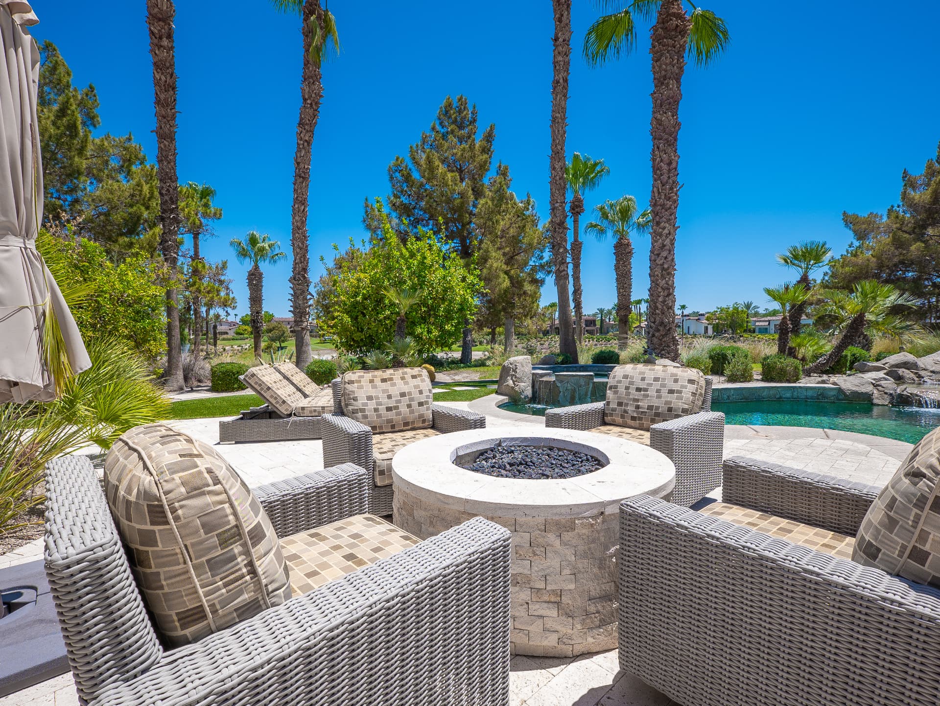 Travertine fire pit terrace beside the rock spa and pool
