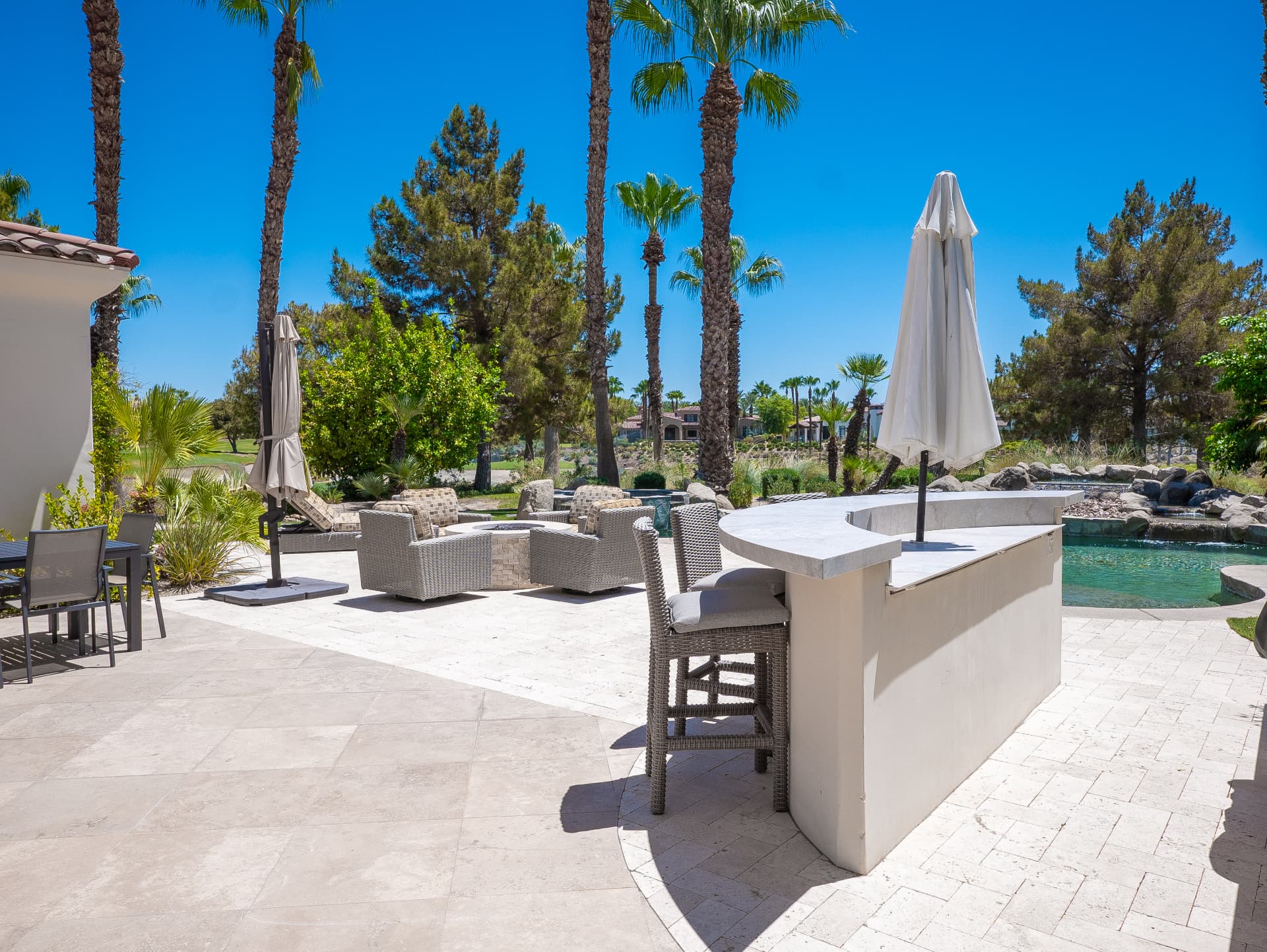 Curved outdoor bar overlooking the pool and golf course